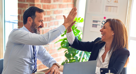 marketing professionals high fiving each other