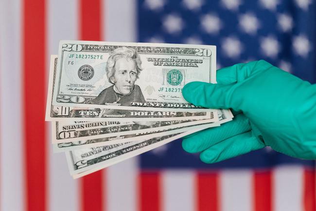 doctor holding money surgical gloved hand holding united states currency